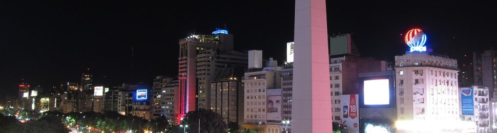 night time scene of buenos aires' obelisk in the middle of a bustling intersection