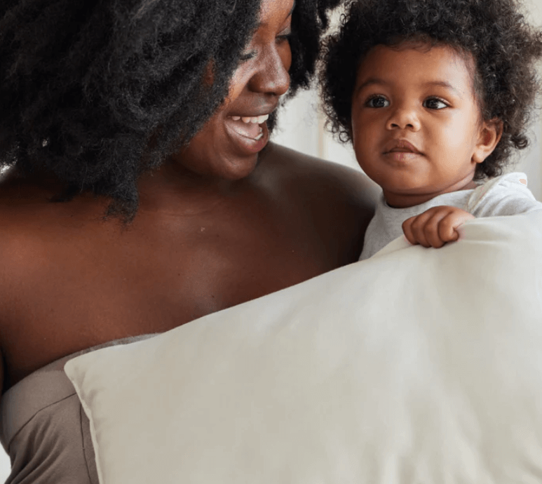 Woman and toddler holding brentwood pillow