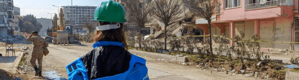 A PETA supporter looks at buildings devastated by an earthquake