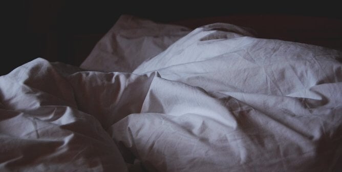 white comforter in a dark room