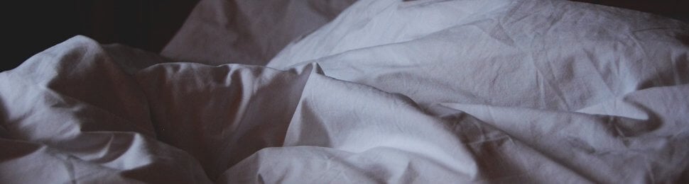 white comforter in a dark room