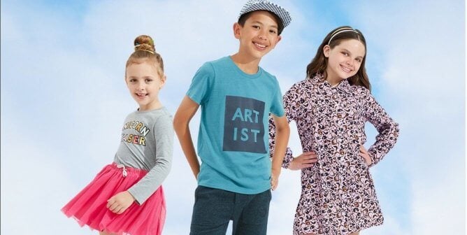 Three kids (two girls and a boy in the middle) in vegan clothes from Rockets of Awesome