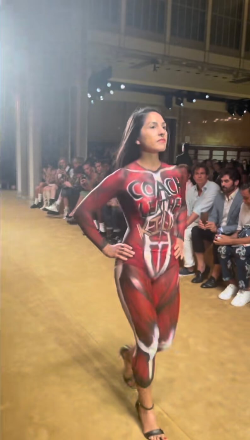 Activist at New York Fashion Week Coach show Leather Kills bodypaint sign