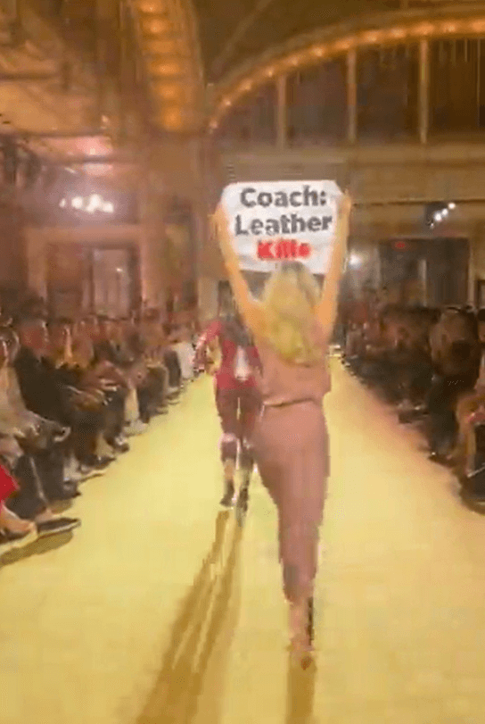 Activist at New York Fashion Week Coach show Leather Kills bodypaint sign