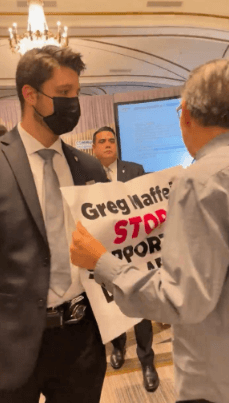 Protester asking Liberty CEO Greg Maffei to end GCI's sponsorship of Iditarod dog-sled race, at Goldman Sachs Communacopia + Technology Conference in San Francisco