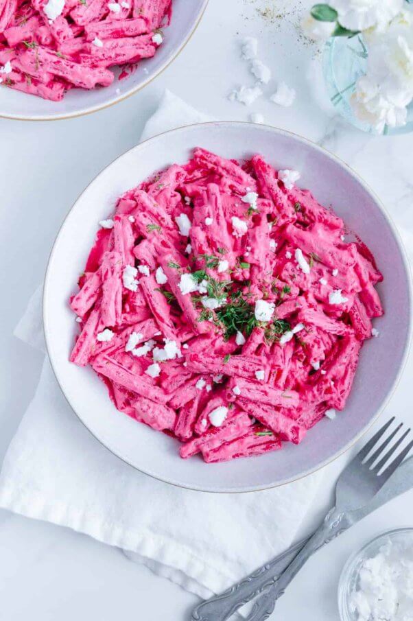a plate of pasta with a vegan pink sauce