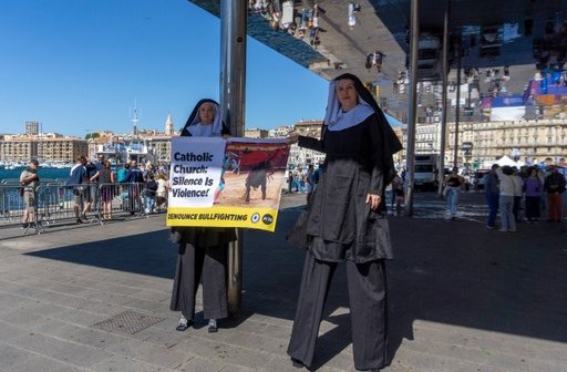 PETA UK supporters dress as nuns on stilts