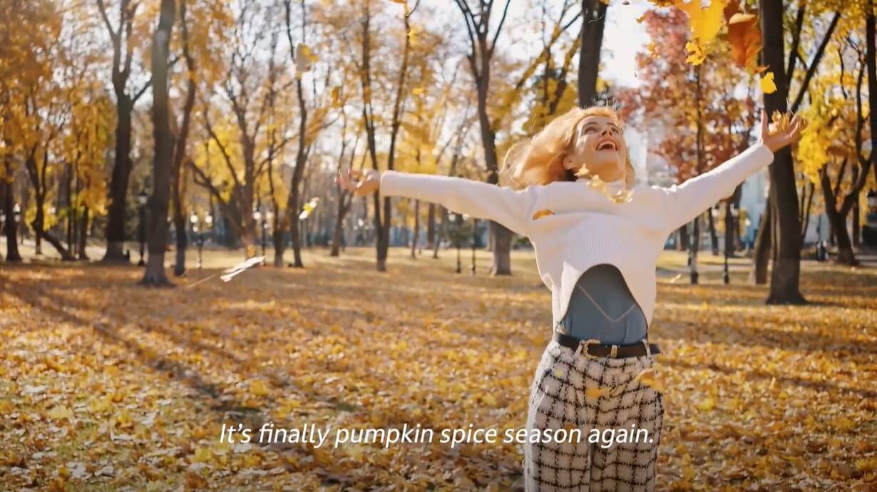woman spins through fall scene to celebrate