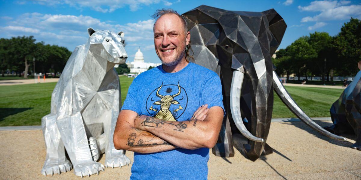 Quill Hyde standing in front of the Council of Animals exhibit