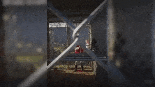 Gif of a worker threatening an animal with a shovel inside a cage