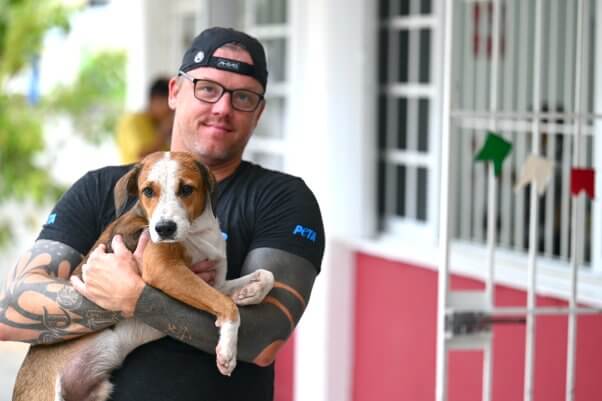PETA staff holds a dog in Cancun for the spay/neuter event