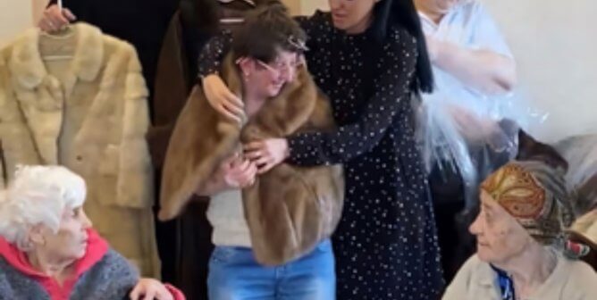 teams supported by PETA donating fur coats to Ukraine, showing one person trying on a coat with others watching