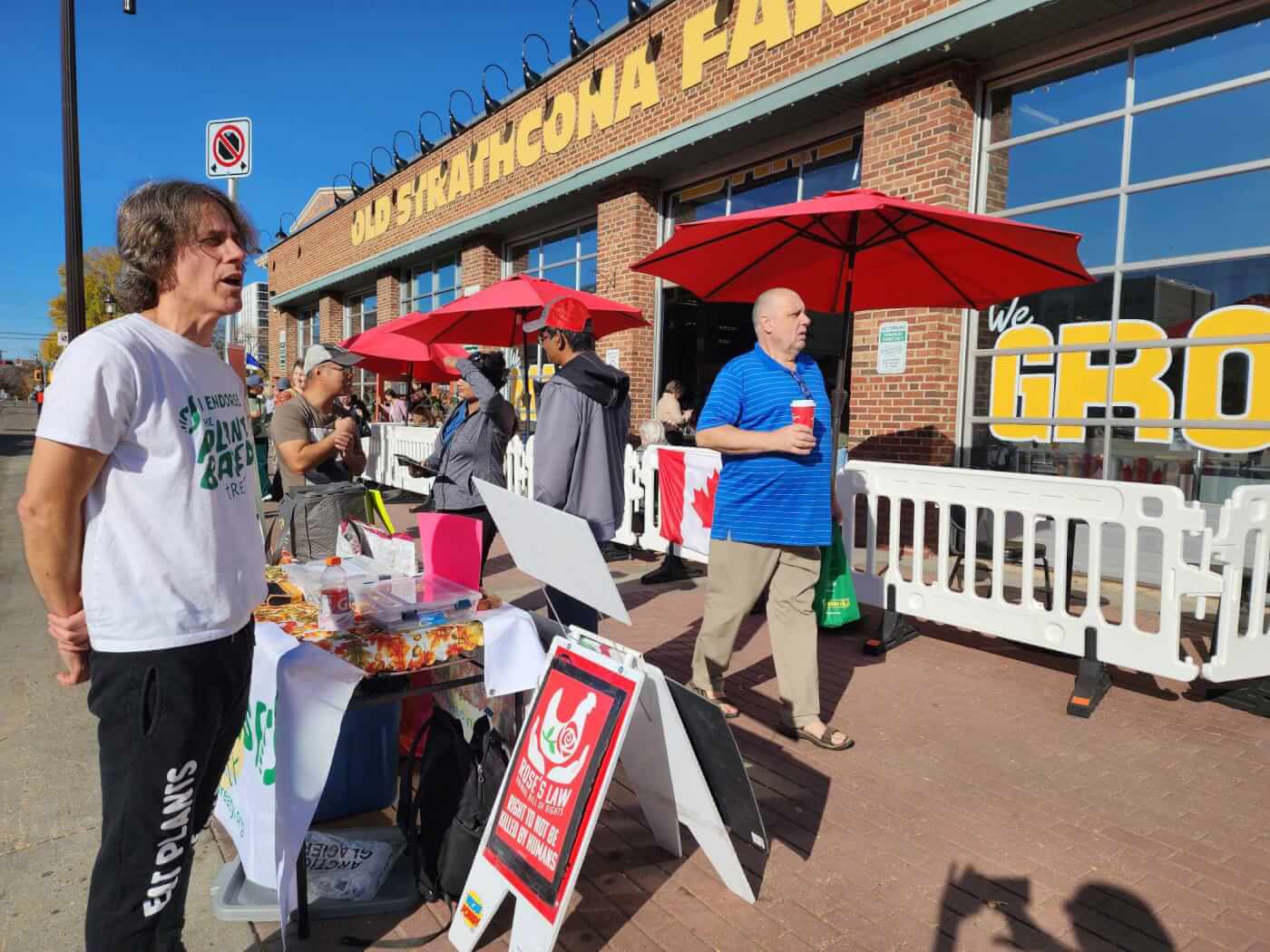 peta supporters at a thanksvegan themed table talking to passersby
