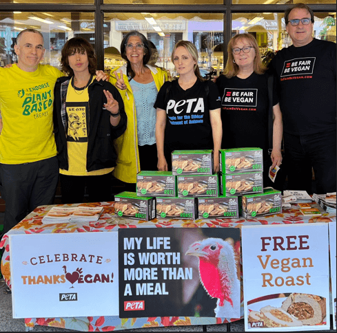 peta supporters at a table with vegan thanksgiving roasts
