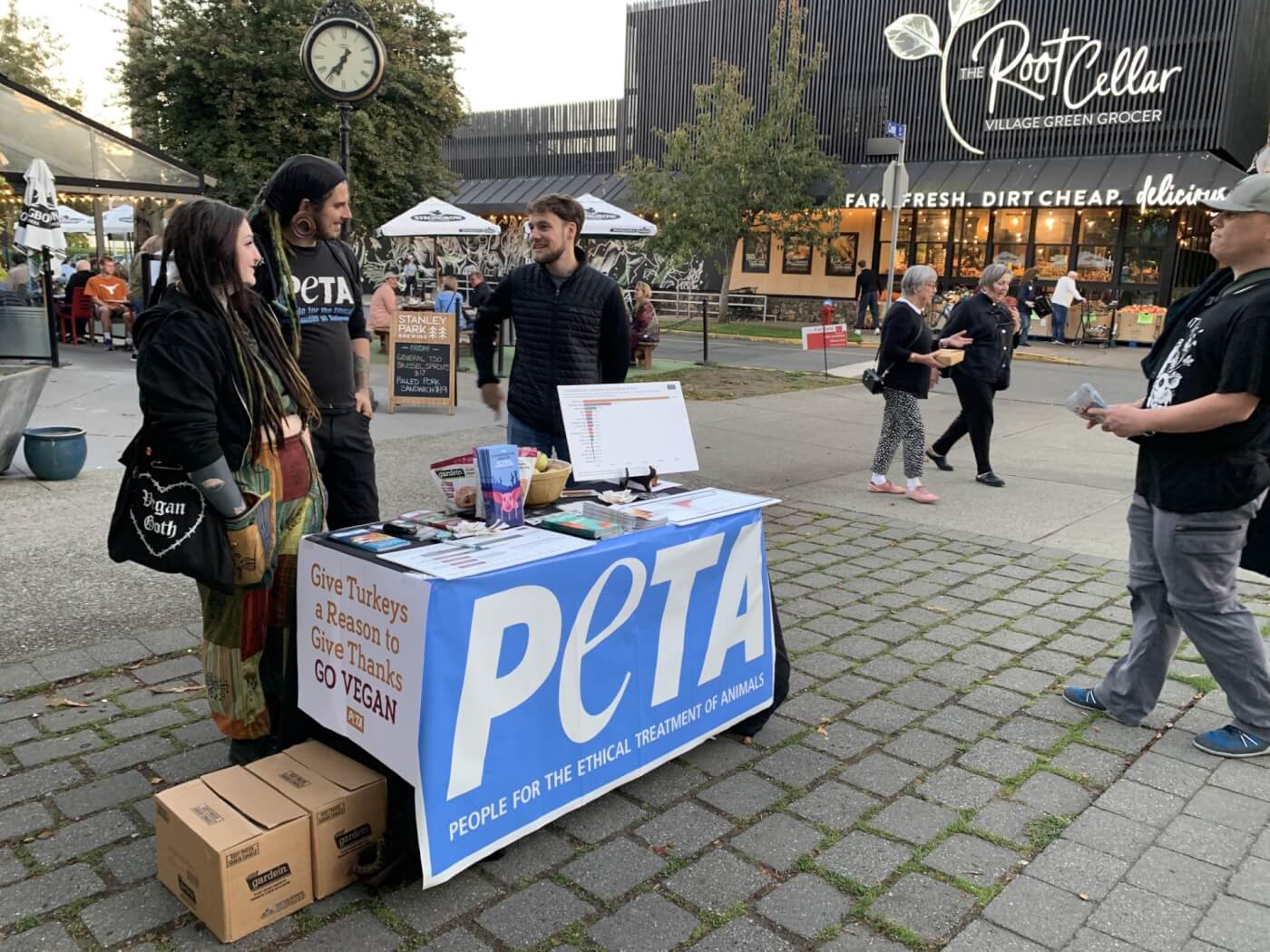peta supporters in a busy plaza handing out leaflets about going vegan
