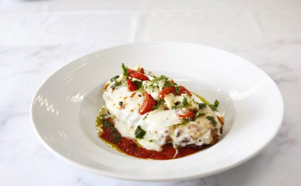 a plate of vegan eggplant parmigiana served on Carnival cruises