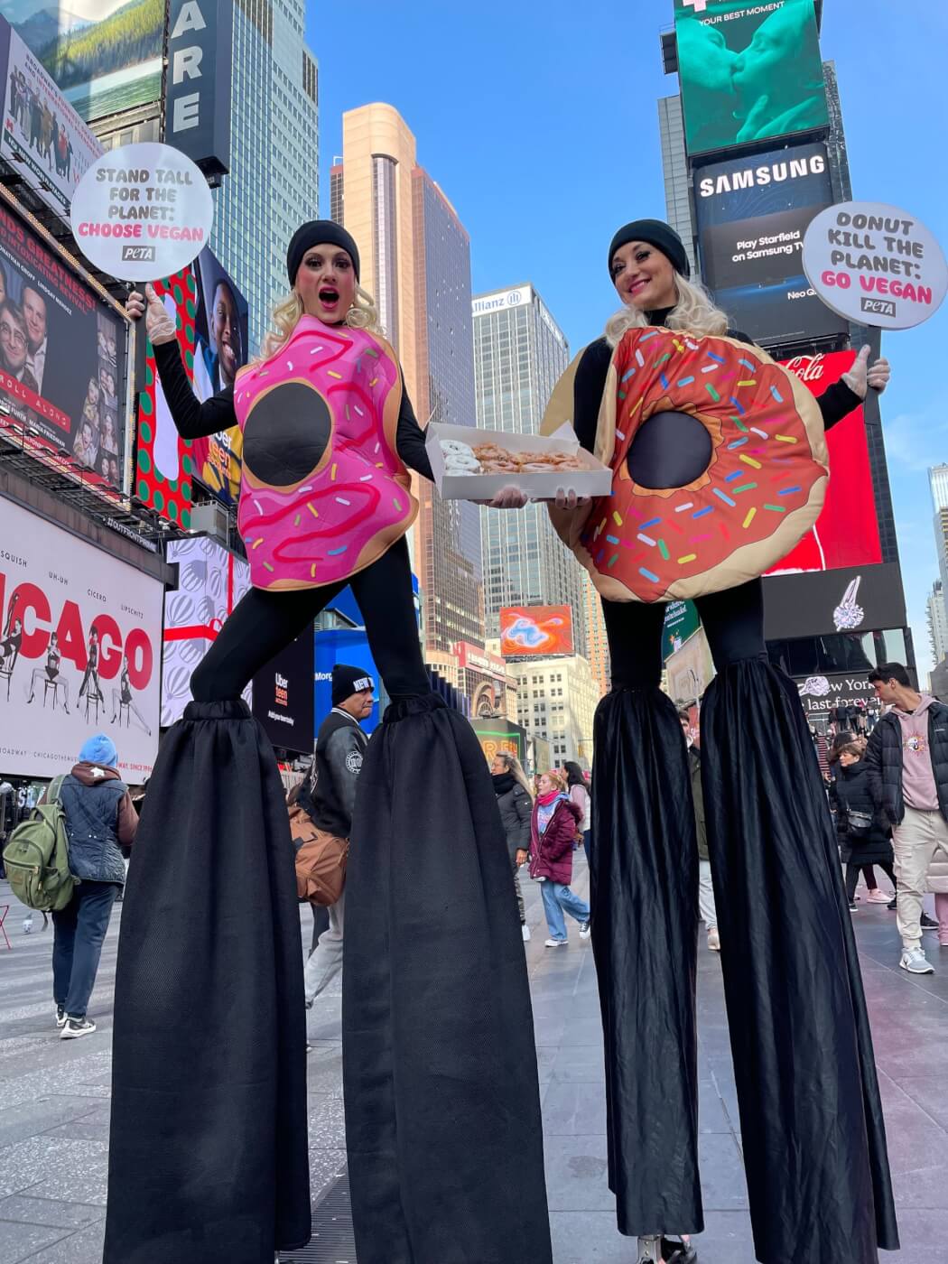 PETA supporters on stilts are dressed as donuts in Times Square