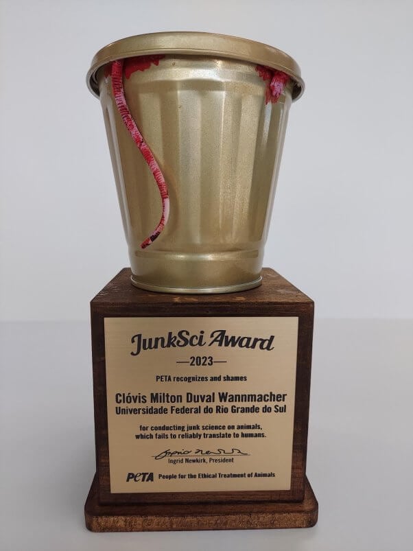 Photo of the JunkSci award trophy, featuring a golden garbage can with a blood stained rim