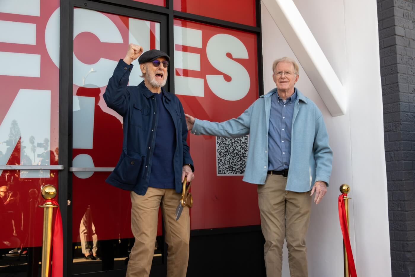 Phot showing James Cromwell cheering after ribbon is cut
