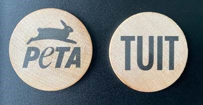 Photo of round wooden tuits with PETA's logo