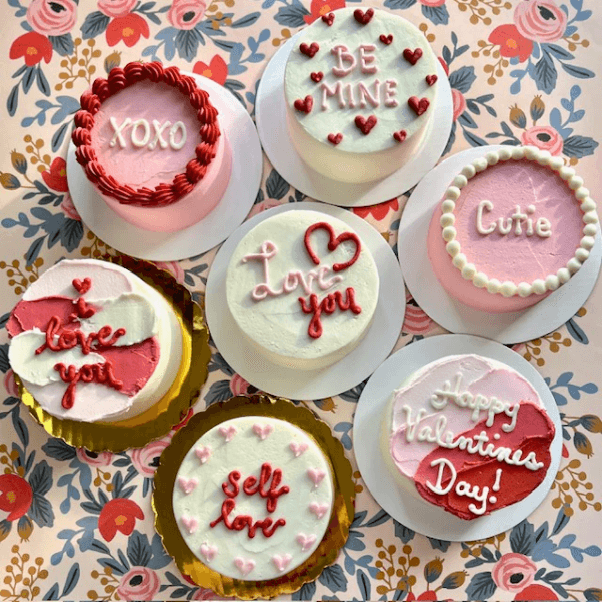 seven vegan mini cakes from Yvonne's Vegan Kitchen, each with a different Valentine's Day design