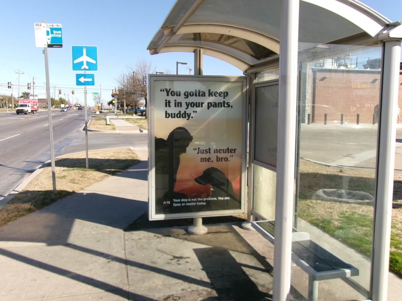bus ad featuring a man with a dog who says "just neuter me"