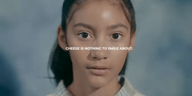 girl posing for a school photo with text saying "cheese is nothing to smile about"