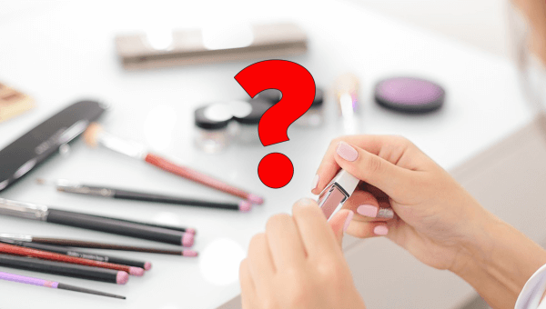 A red question mark over top of an image of makeup.