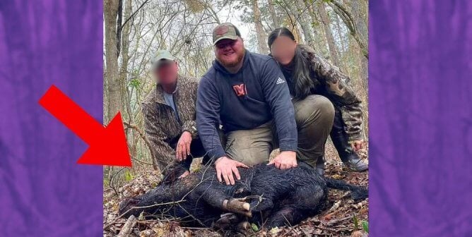 Will Moseley posing with a dead pig with two other hunters, whose faces are blurred