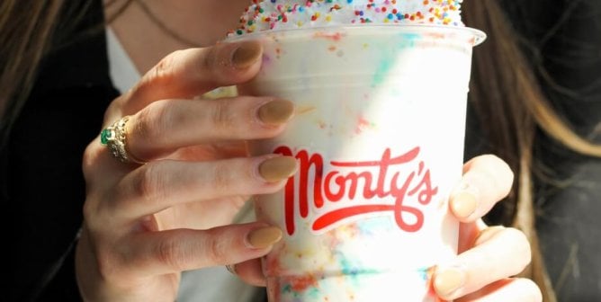 A person drinking a Monty's shake