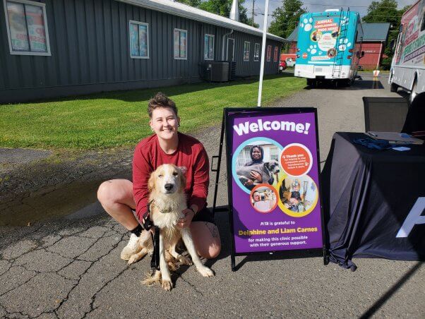 person and companion dog at spay/neuter clinic in galax, virginia