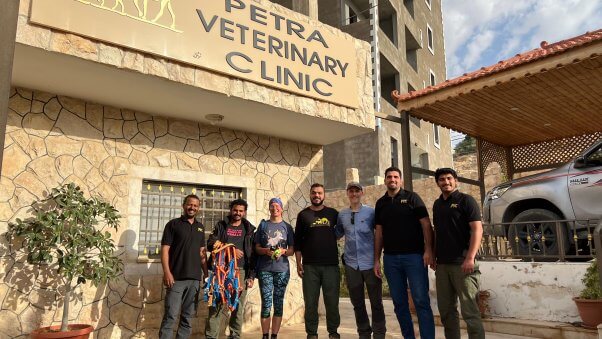 Julie H and her colleague pose for a picture with staff from the Petra Veterinary Clinic in Petra, Jordan. 