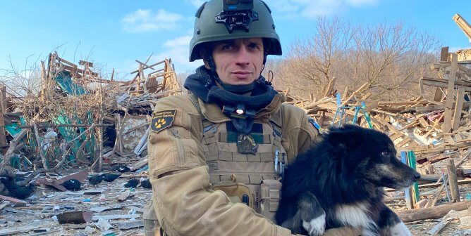 man holding dog rescued in ukraine