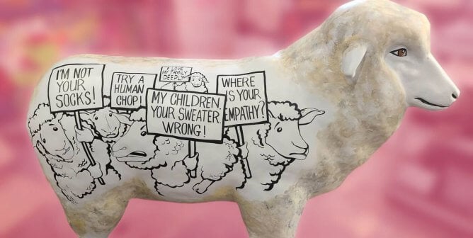 PETA's sheep statue with drawn protesting sheep on the side on the statue.
