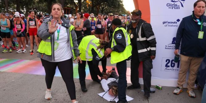Person holding up their hand as a demonstrator is arrested