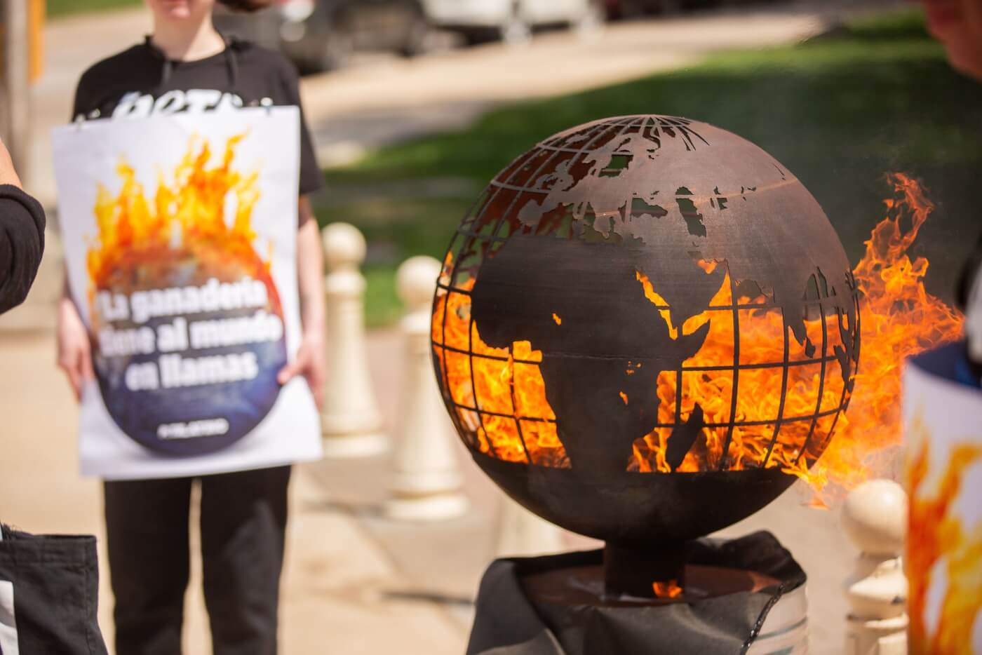 small earth globe on "fire" for earth day protest