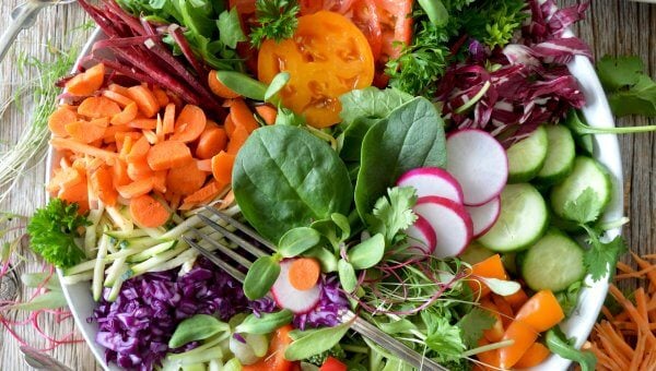 A colorful salad featuring a variety of fruits and vegetables