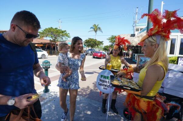 PETA members offer free vegan egg sandwiches on Siesta Key, FL