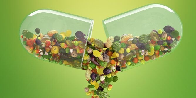 Clear capsule with fruits and veggies spilling out