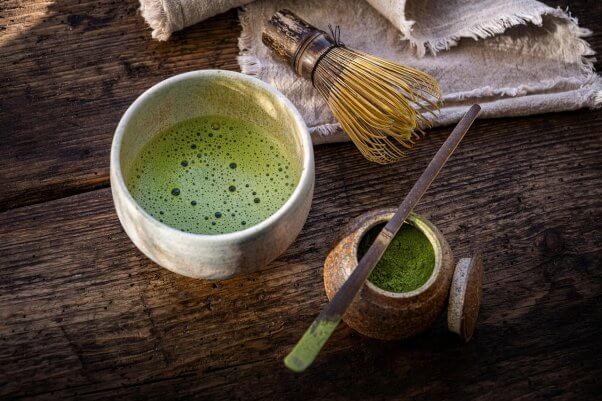 matcha tea in cup with whisk