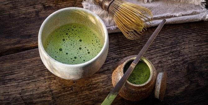 matcha tea in cup with whisk