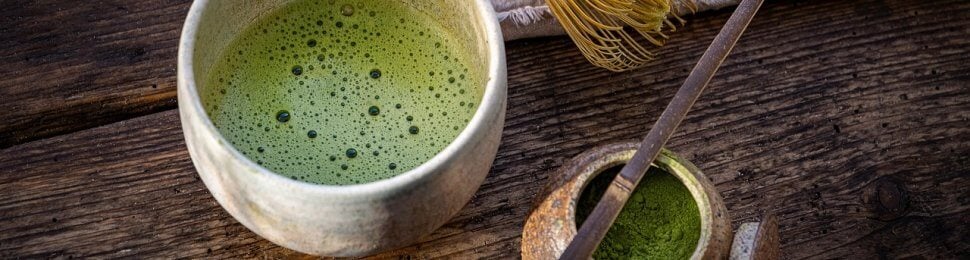 matcha tea in cup with whisk