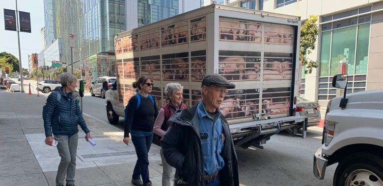 Passerby walking past the Hell on Wheels pig truck