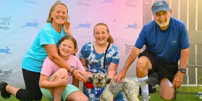 A family posing in front of a backdrop