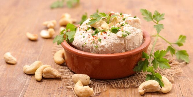 cashew cheese and loose cashews and herbs