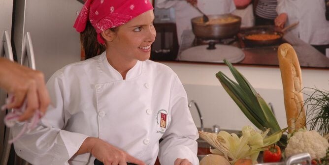 a chef chops peppers in the kitchen