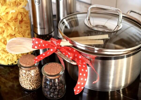 pot and cooking utensils on counter with red bow