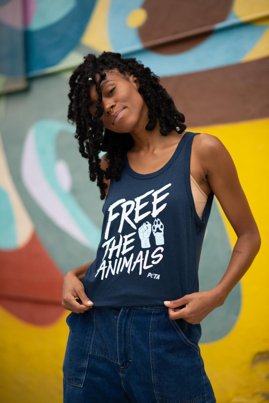 A person wearing a free the animals tank top