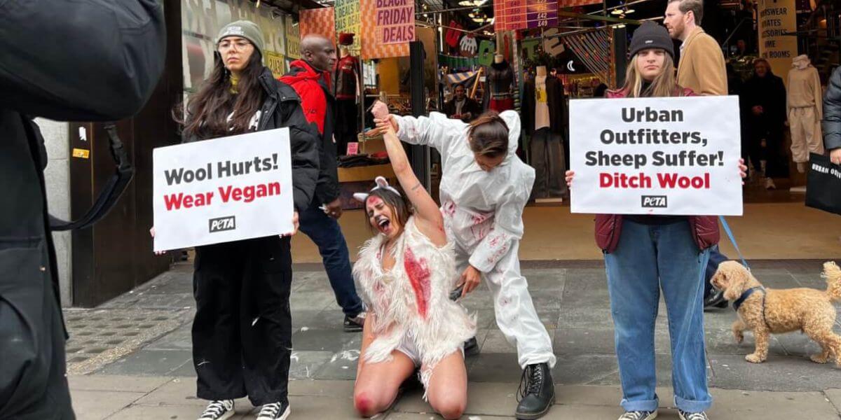 A demonstrator is 'shorn' in front of an Urban Outfitters