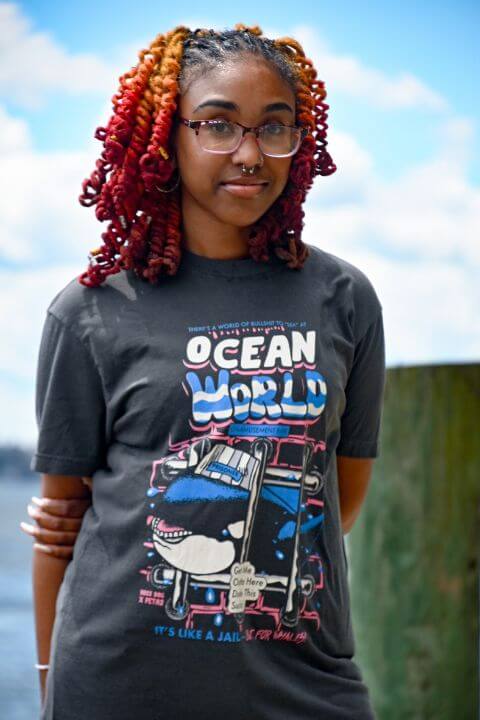 Model wearing a peta2 shirt available in the PETA Shop